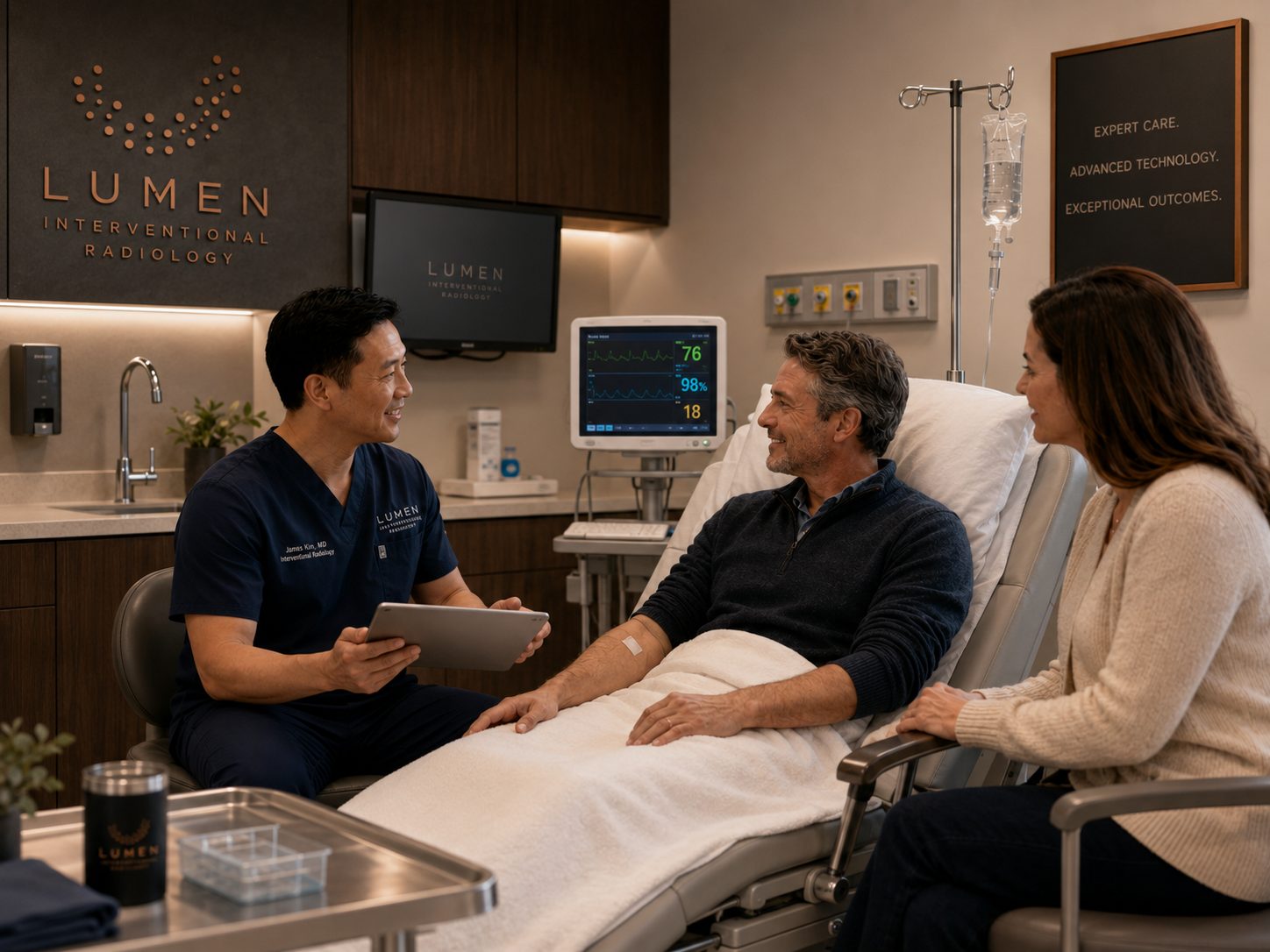 A patient and partner with their interventional radiologist in the Lumen procedure suite